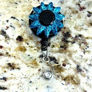 Blue and black sunflower badge reel.